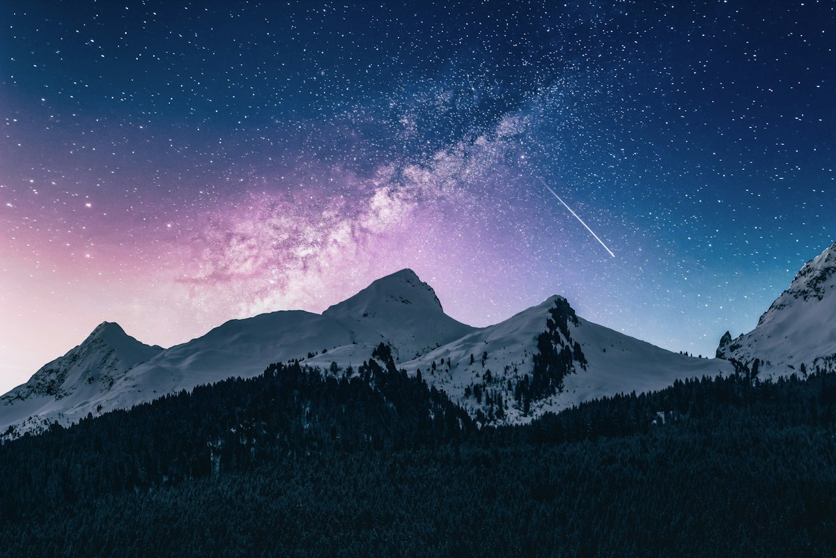 Mountains under starry night sky at MoonFaire
